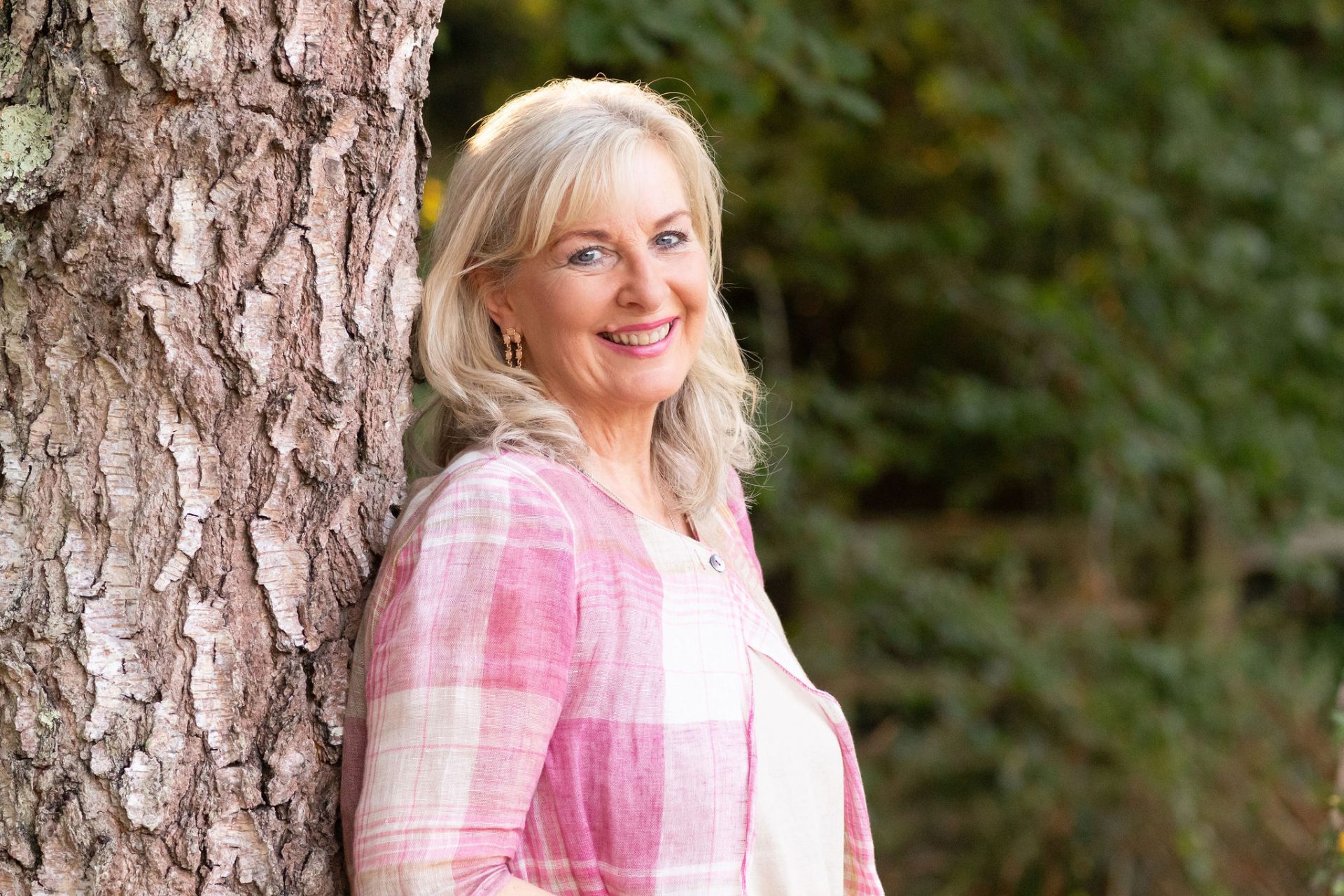 Portrait of Sue Weller smiling outdoors.
